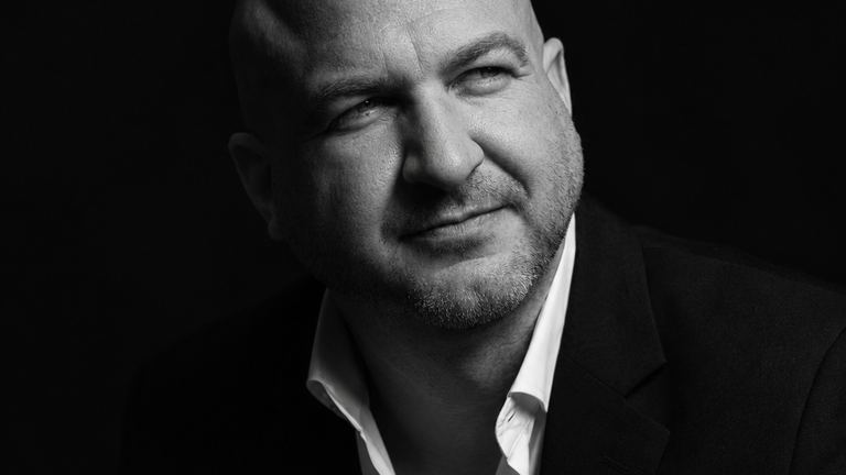 Nick Cavuoto in a white shirt and jacket, executive portrait.