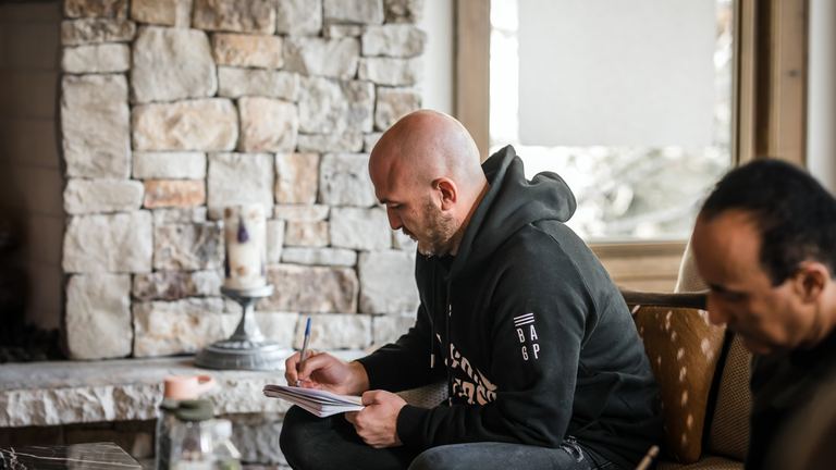 Nick Cavuoto writing notes at a table.