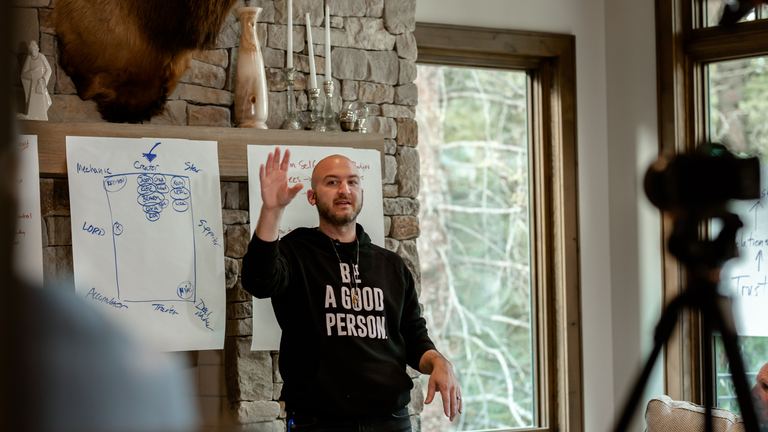 Nick Cavuoto teaching at a whiteboard during a working session.