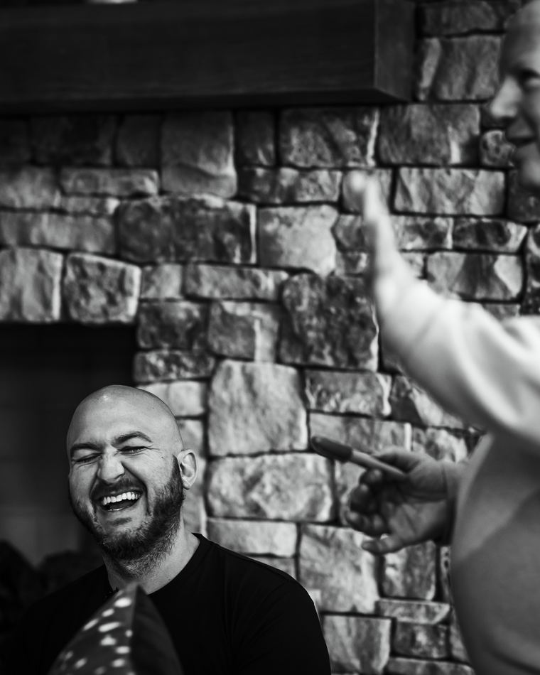 Nick Cavuoto laughing with a client, in black and white.