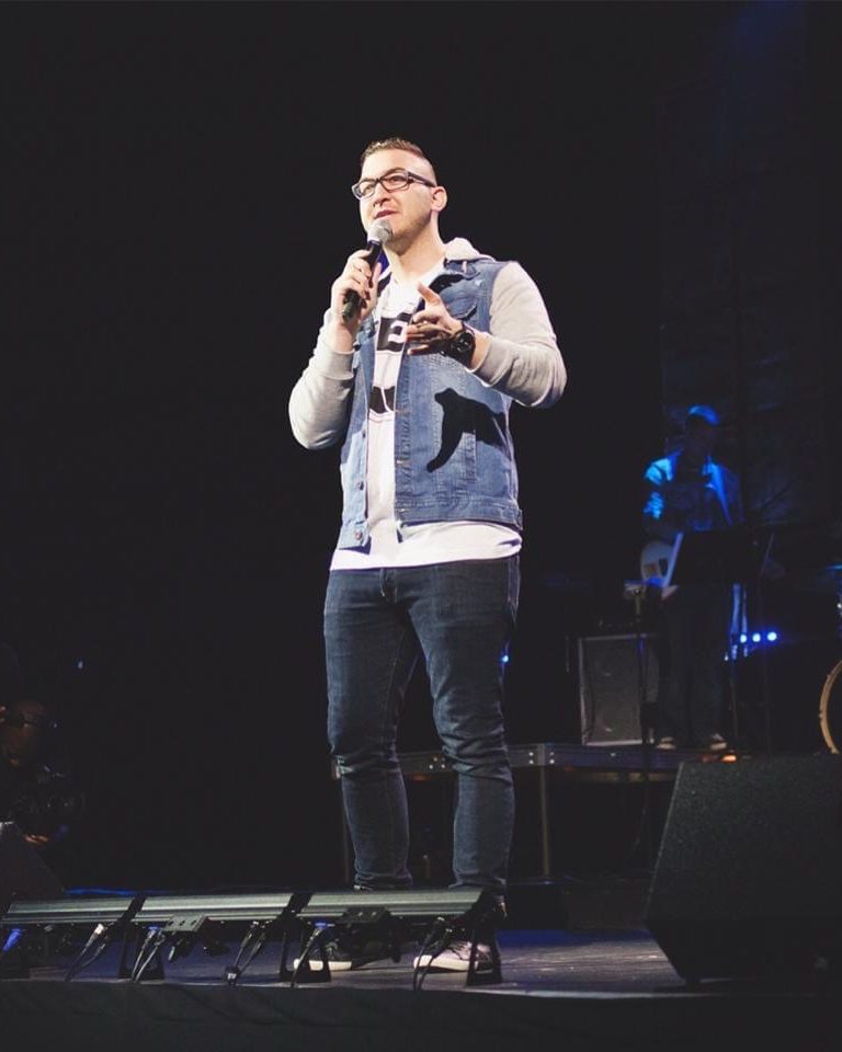 Nick Cavuoto speaking on stage during his ministry years.
